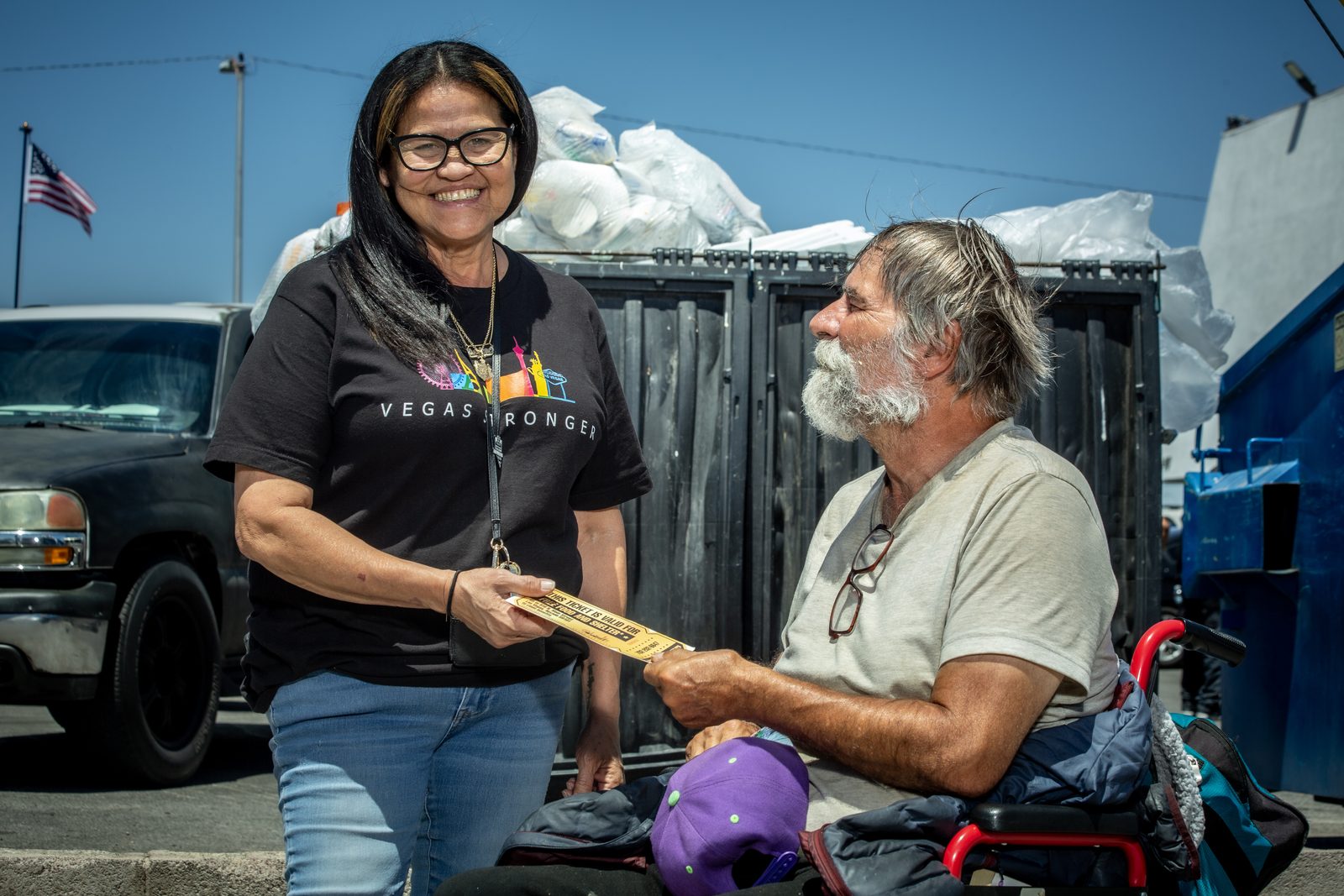 Volunteer smiling with homeless man during outreach