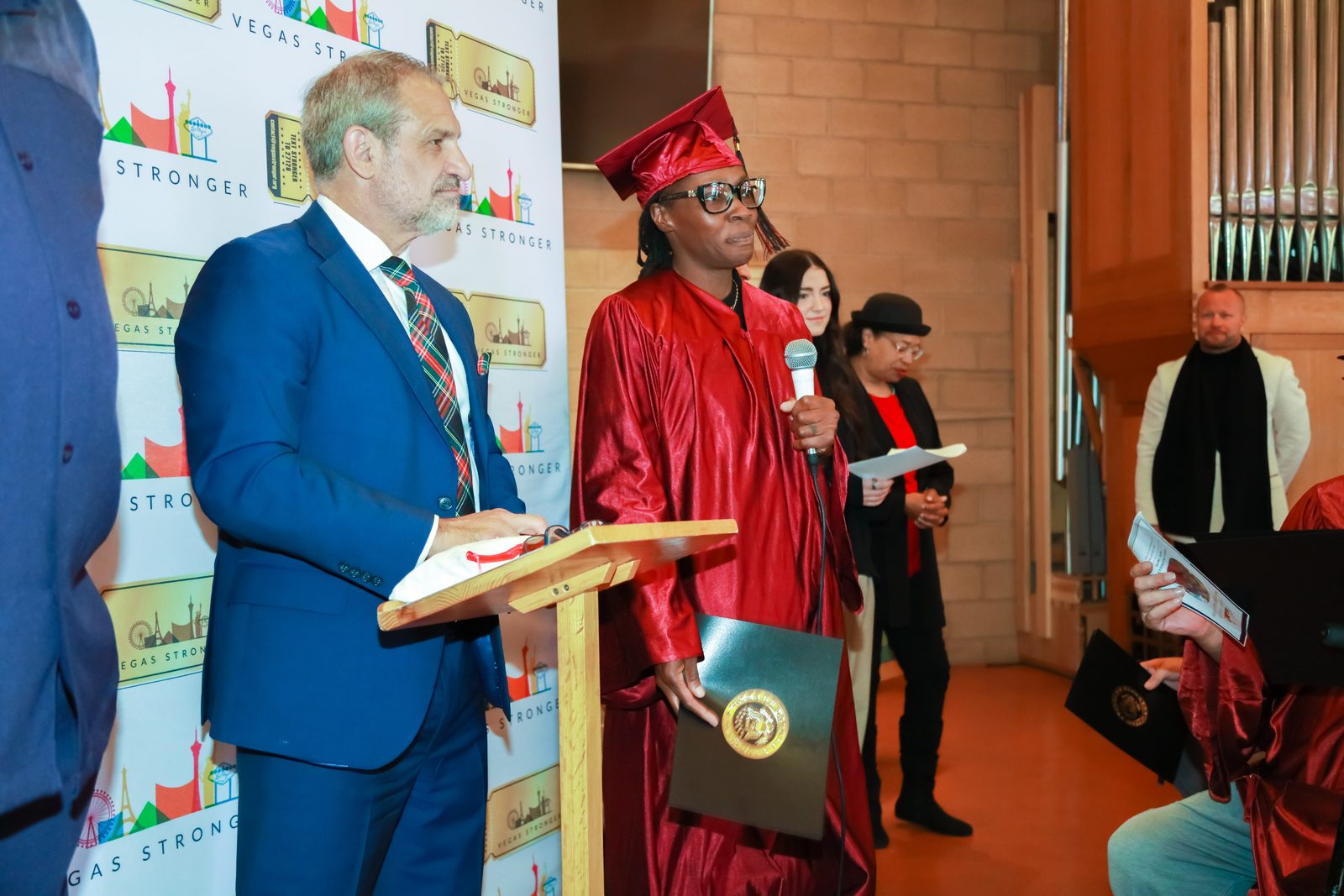 Graduate speaking at podium during Vegas Stronger event
