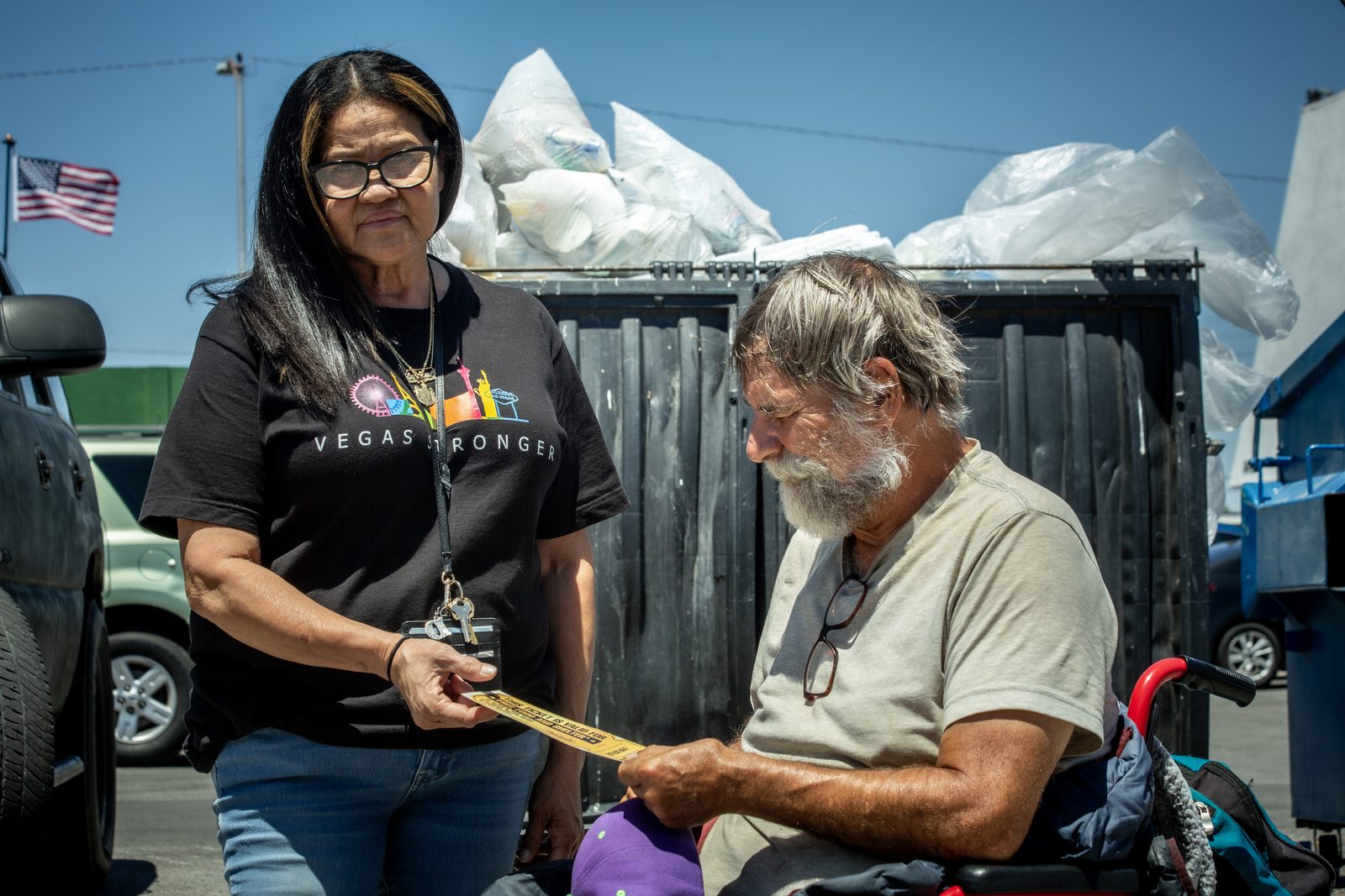 Staff member helps homeless man during outreach