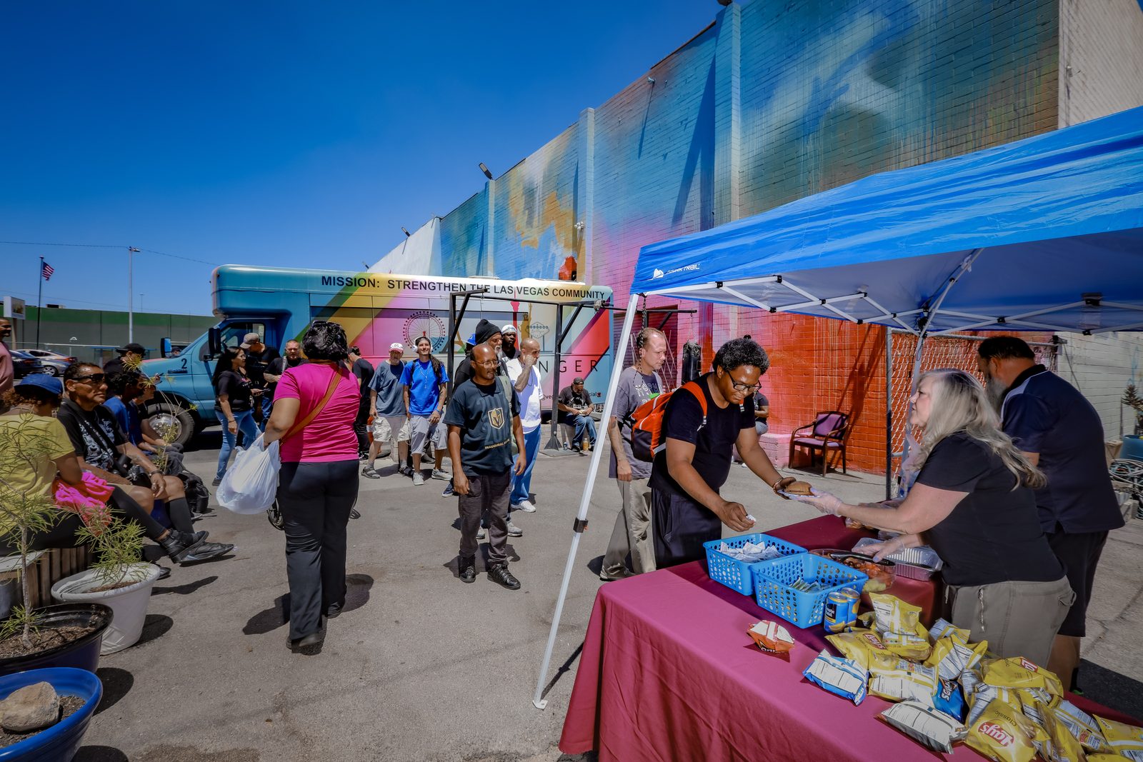Vegas Stronger staff smiling with homeless man outdoors