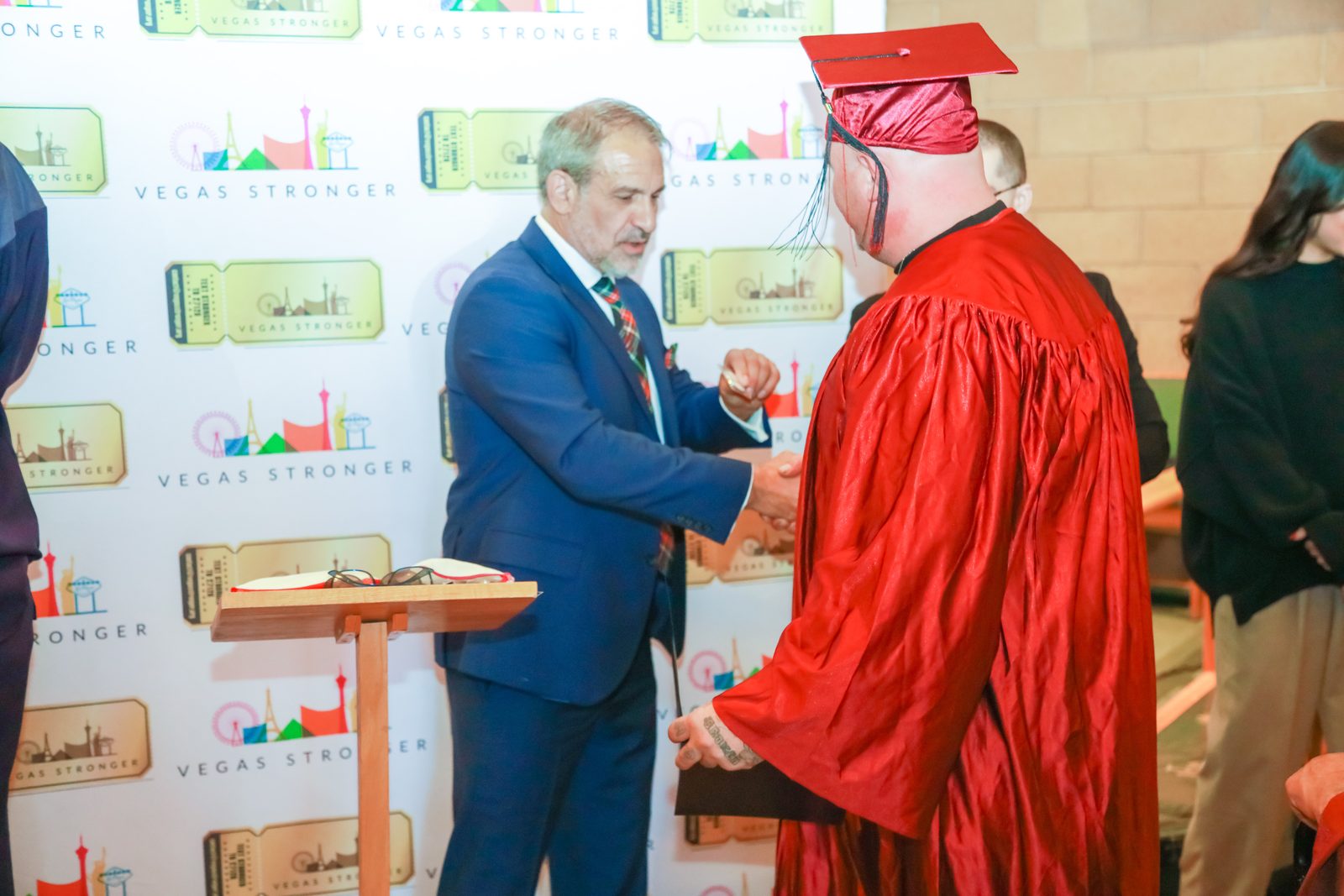 Program leader shakes hands with recovery graduate