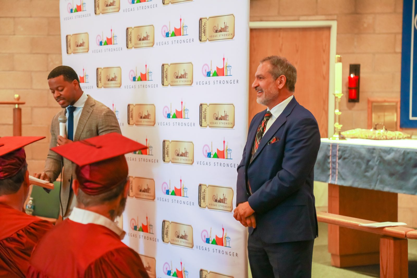 Man reads notes at podium during Vegas Stronger ceremony