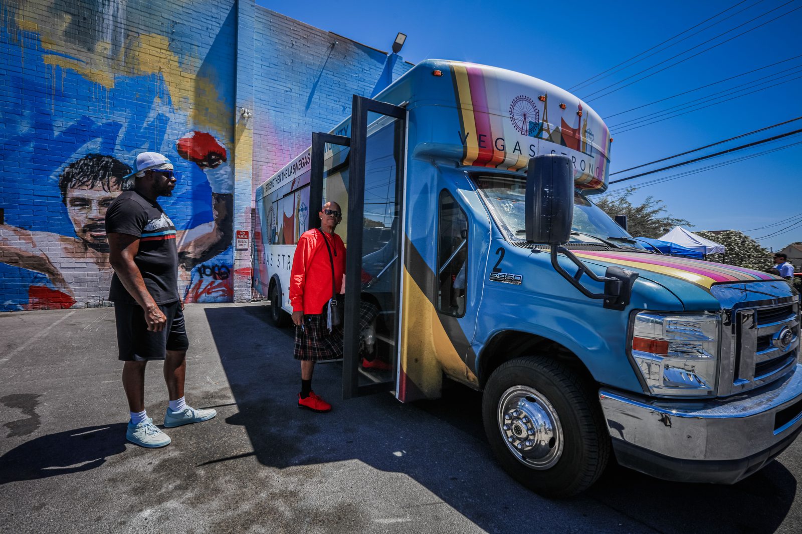 Men near Vegas Stronger community outreach bus