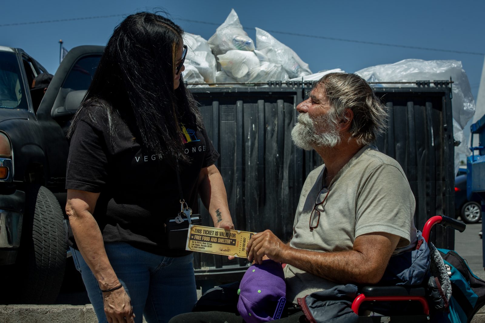 Vegas Stronger volunteer assisting homeless man in wheelchair