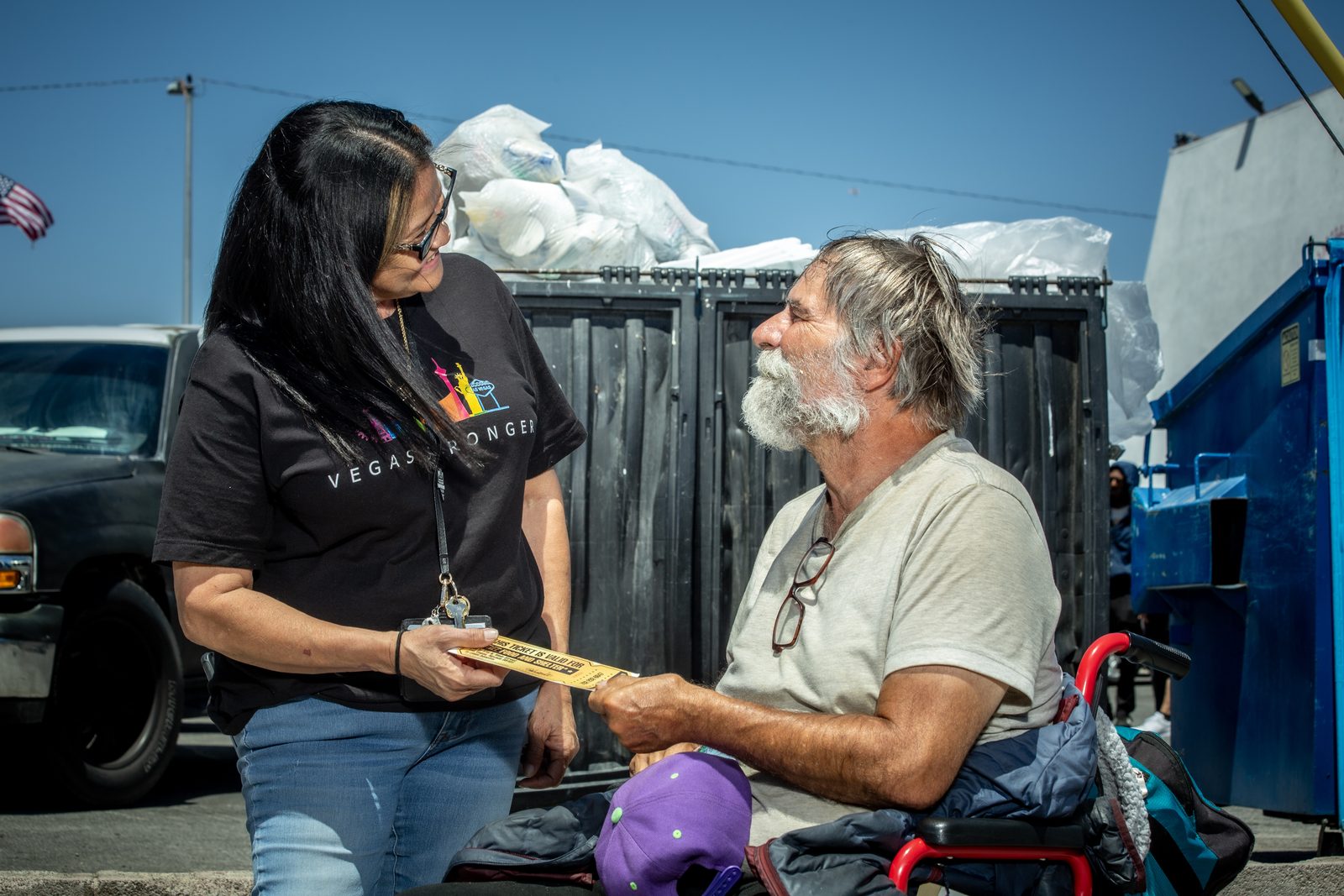 Vegas Stronger staff assisting homeless man on street