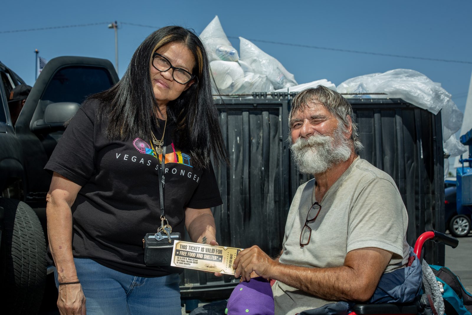Vegas Stronger volunteer helping homeless man outdoors