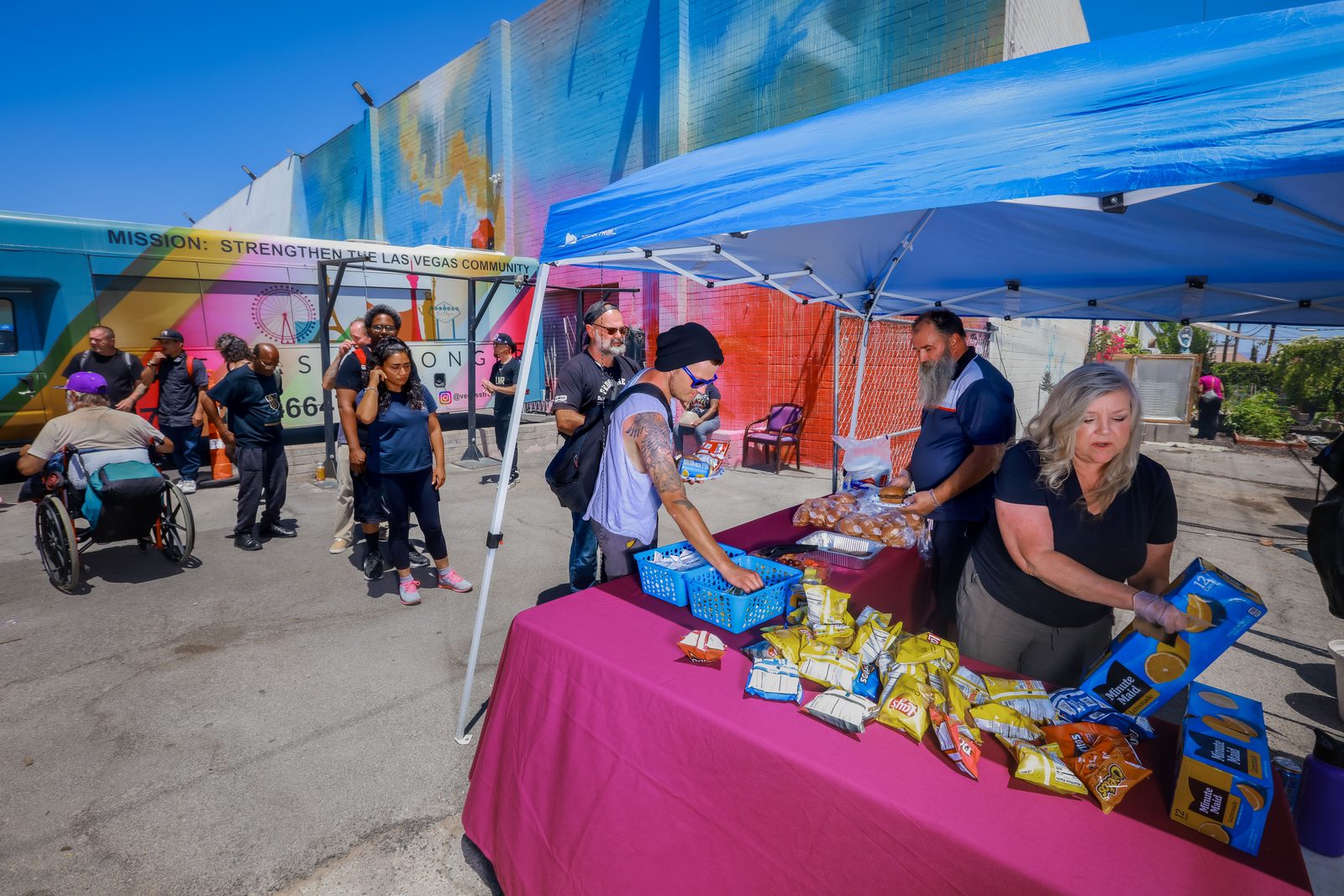 Crowd at food distribution event beside Vegas Stronger bus