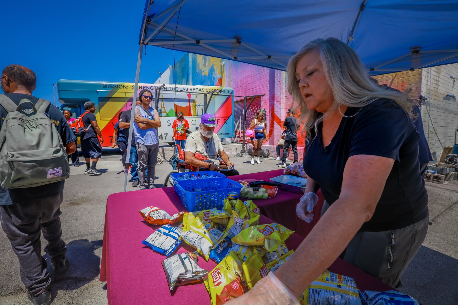 Volunteer organizes snacks at food distribution table