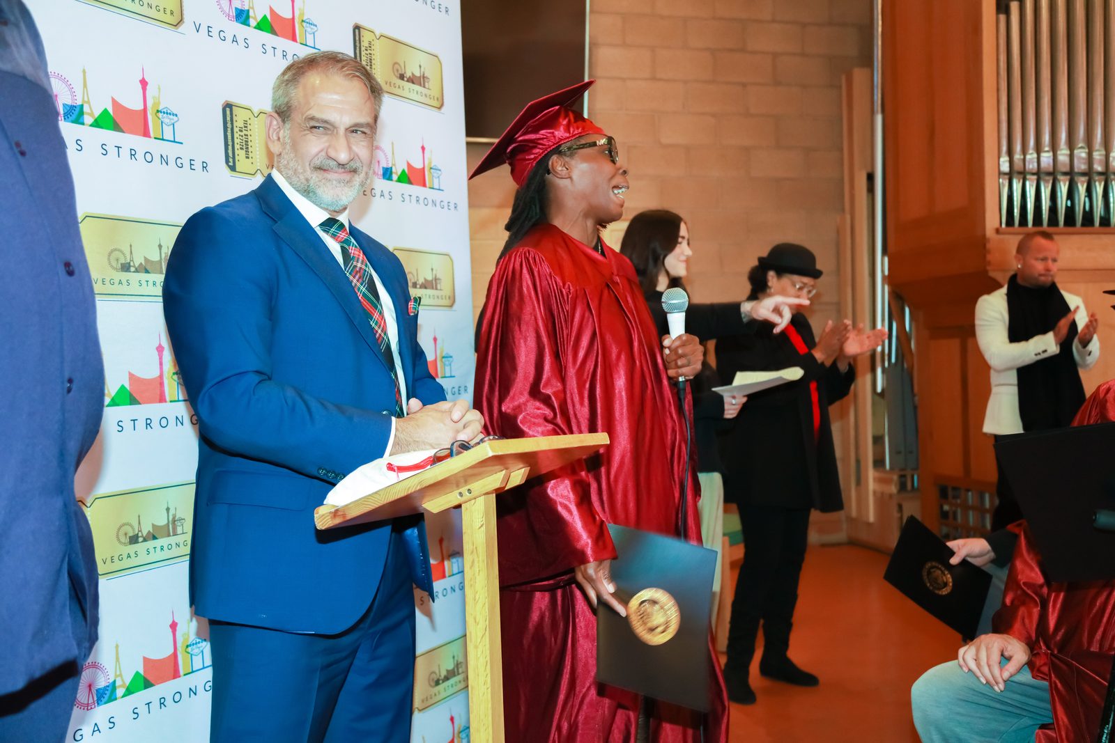 Graduate at podium during Vegas Stronger graduation ceremony
