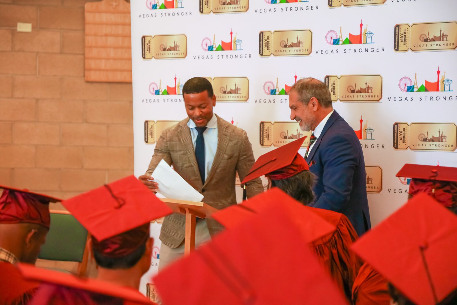 Man reviews document at podium during Vegas Stronger ceremony