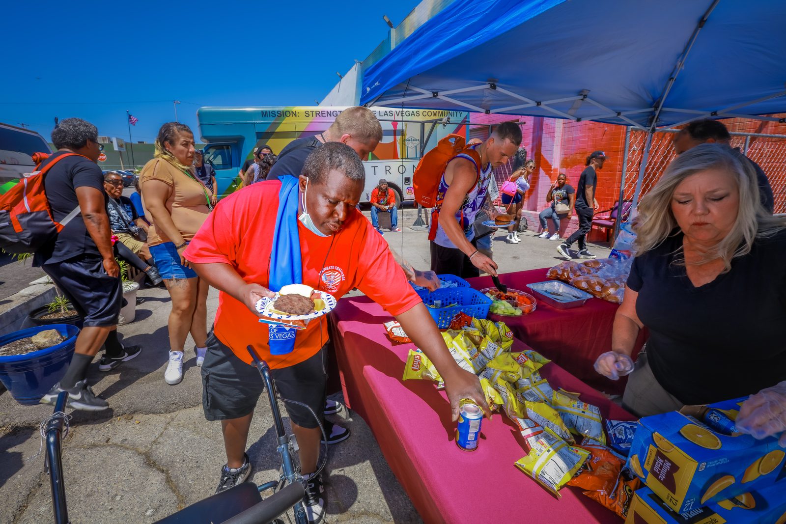 Man receiving food at community distribution table