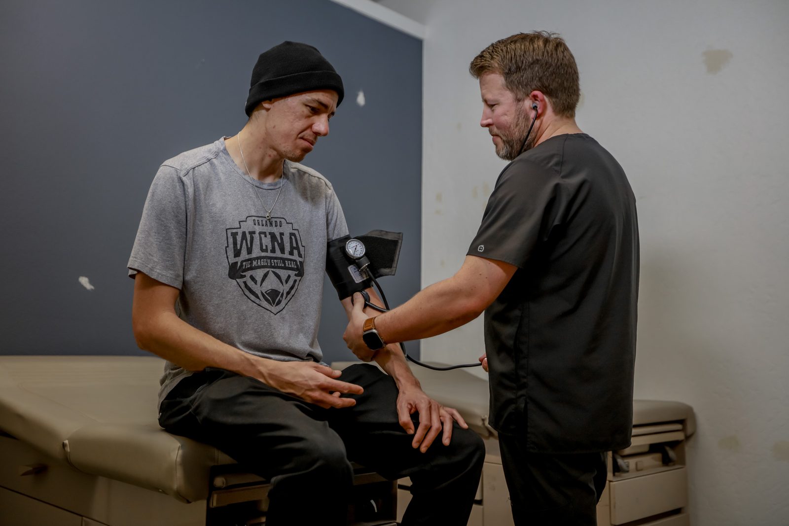 Clinic staff conducting health check on client